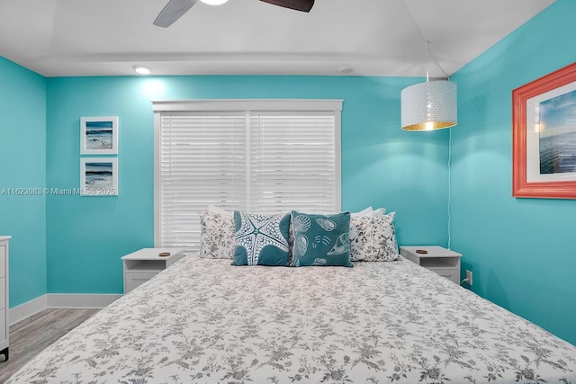 bedroom with hardwood / wood-style floors and ceiling fan