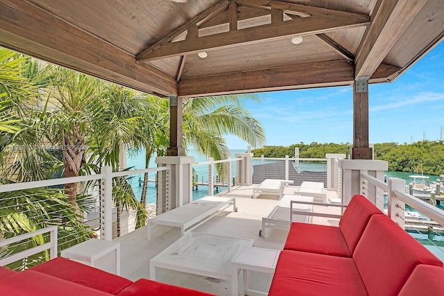 view of patio with a water view, a gazebo, and an outdoor hangout area