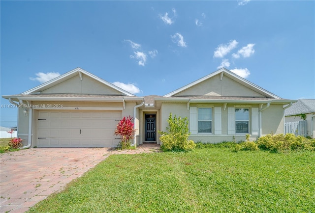 ranch-style house with a garage and a front yard