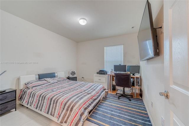 bedroom with tile patterned floors and baseboards