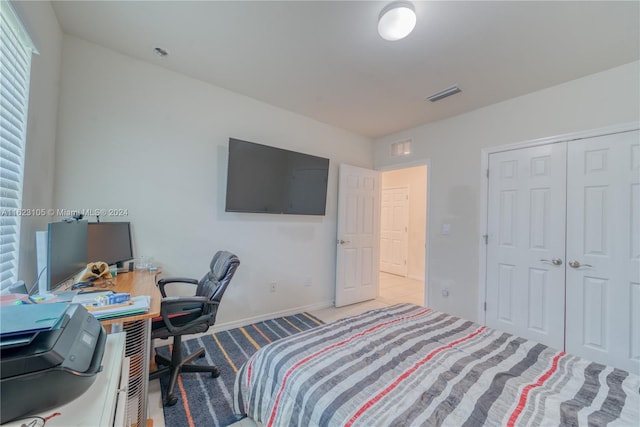 carpeted bedroom featuring a closet, visible vents, and baseboards