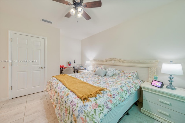 bedroom featuring light tile patterned floors, a ceiling fan, and visible vents