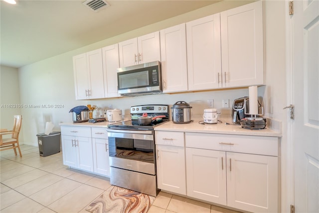 kitchen with visible vents, appliances with stainless steel finishes, white cabinetry, and light countertops