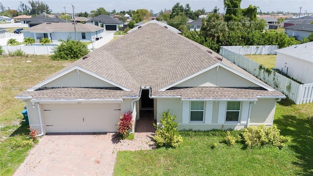 ranch-style home featuring decorative driveway, stucco siding, an attached garage, and a shingled roof