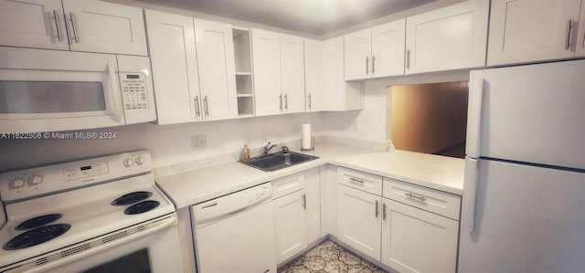 kitchen with white appliances, a sink, white cabinets, light countertops, and open shelves