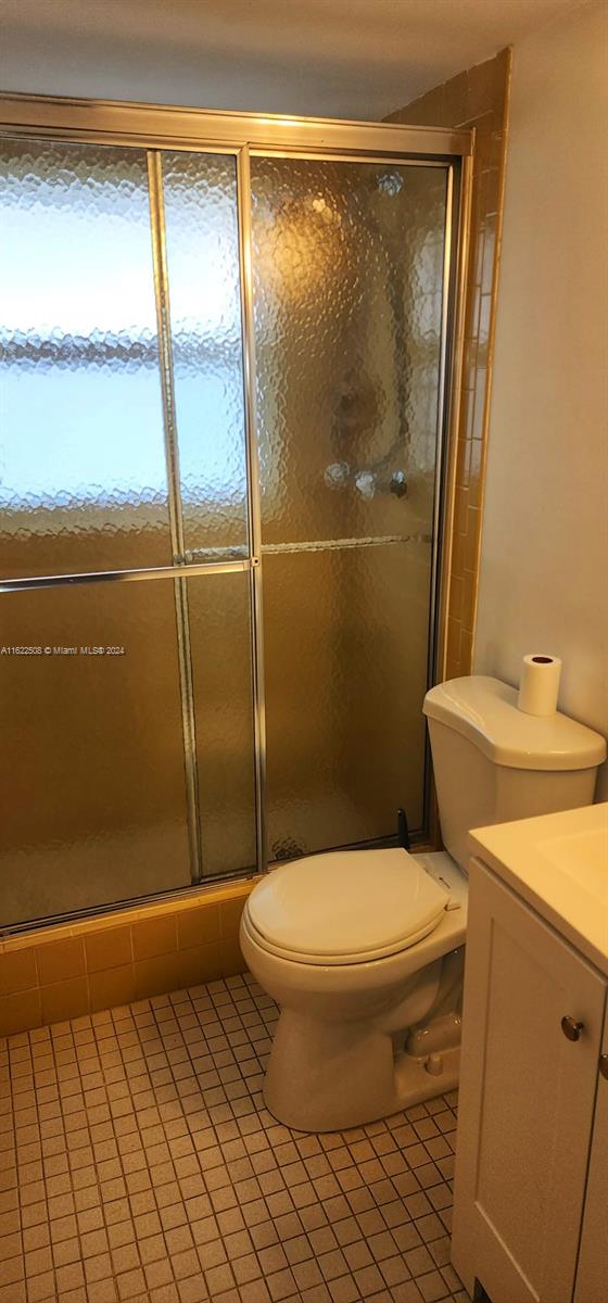 bathroom with tile patterned floors, vanity, and toilet