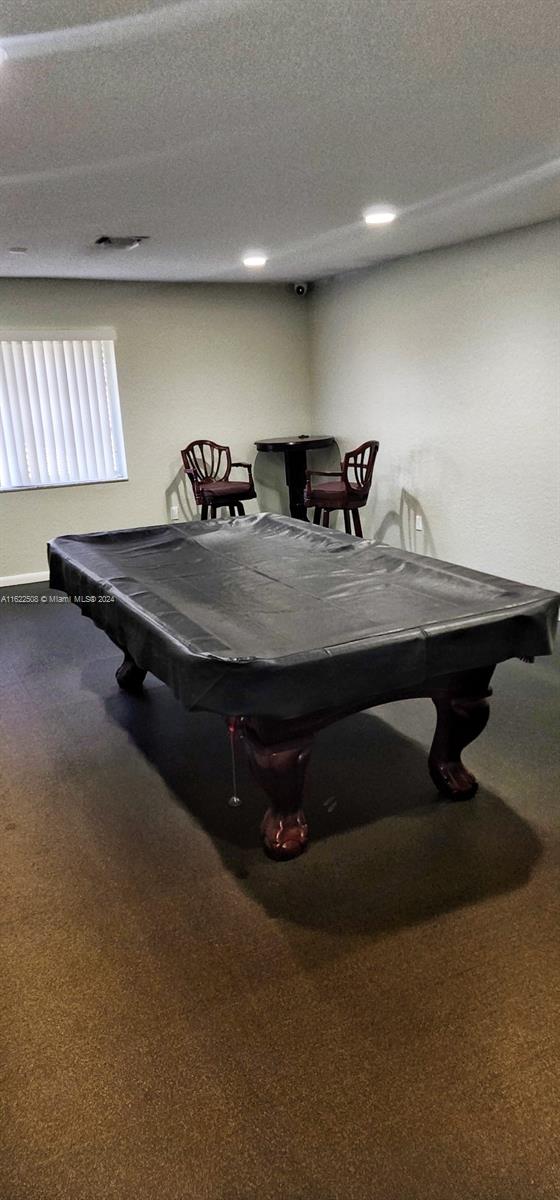 recreation room with pool table, carpet flooring, and a textured ceiling