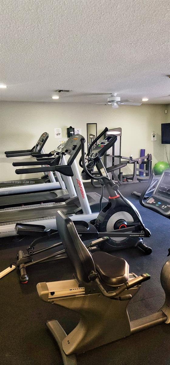 workout area featuring a textured ceiling