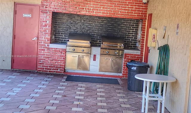 interior space with an outdoor kitchen and a patio area