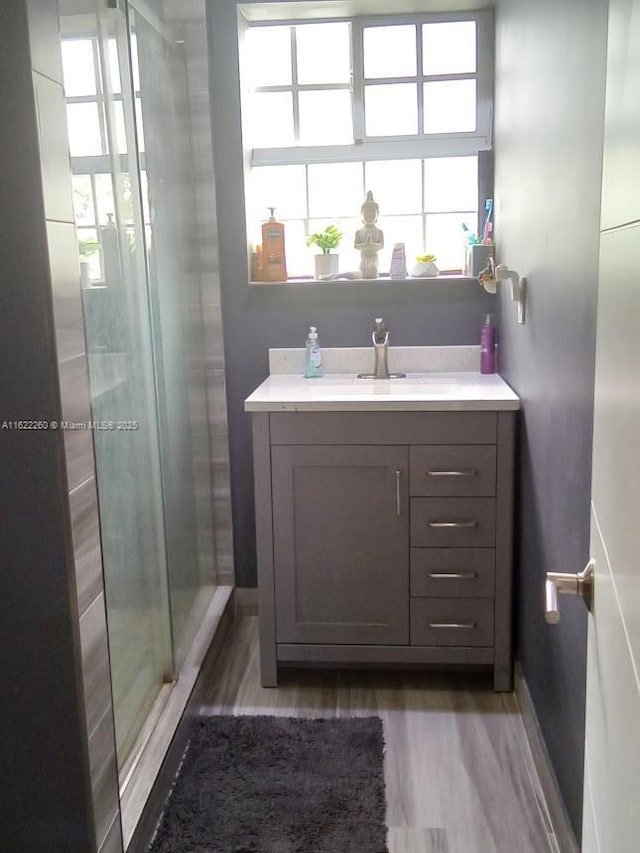 6474 SW 26th St, Miramar, FL 33023 - full bathroom with wood finished floors, a stall shower, vanity, and baseboards