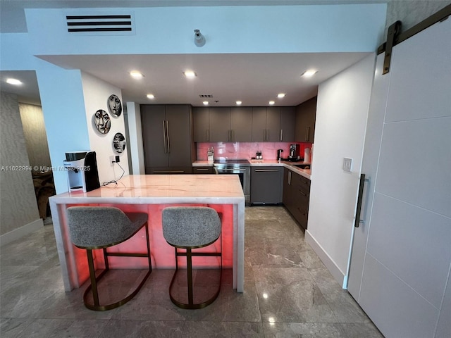 kitchen featuring dishwasher, paneled built in fridge, a breakfast bar, electric range, and a barn door