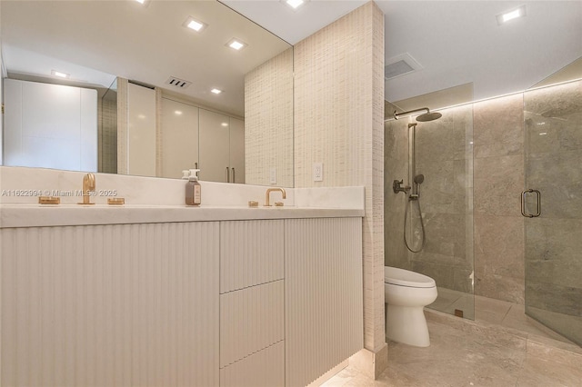 bathroom featuring an enclosed shower, vanity, and toilet