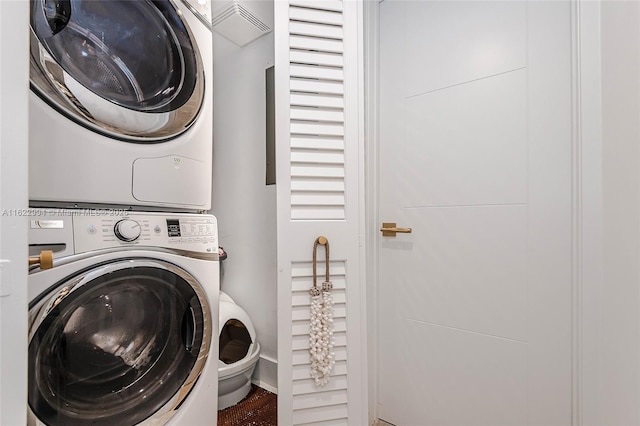 clothes washing area featuring stacked washer / drying machine