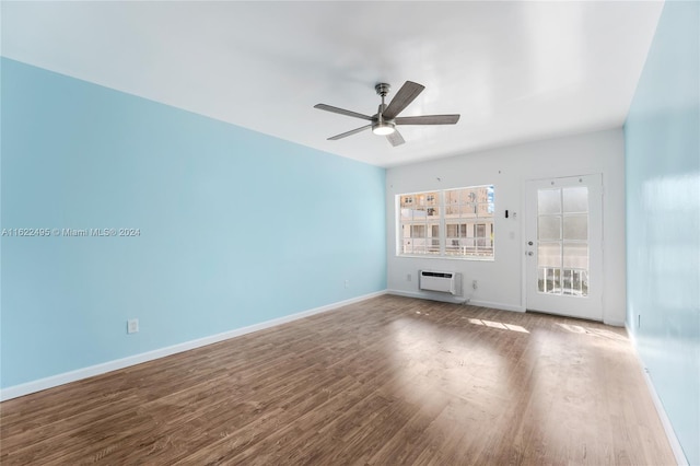 635 8th St Unit 205, Miami Beach, FL 33139 - unfurnished living room with a ceiling fan, wood finished floors, and an AC wall unit
