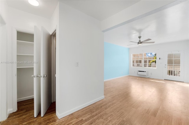 635 8th St Unit 205, Miami Beach, FL 33139 - unfurnished living room featuring a ceiling fan, a wall mounted air conditioner, and wood finished floors