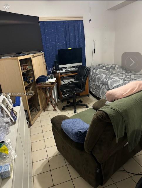 bedroom with light tile patterned floors