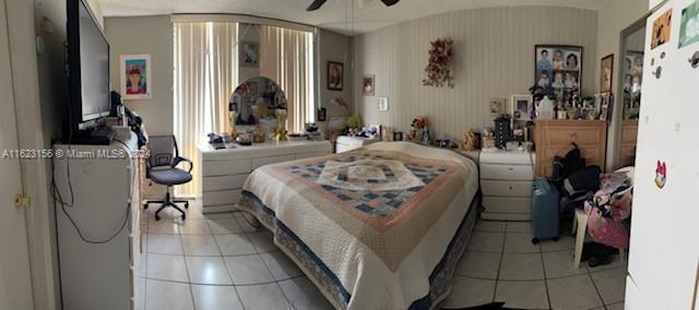 bedroom featuring light tile patterned flooring and ceiling fan