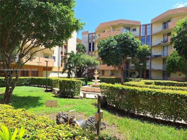 view of property's community with a lawn