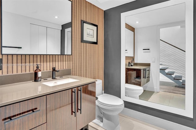 bathroom featuring decorative backsplash, tile patterned flooring, vanity, and toilet