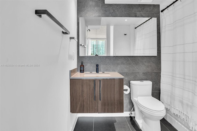 bathroom featuring tile walls, curtained shower, vanity, tile patterned flooring, and toilet