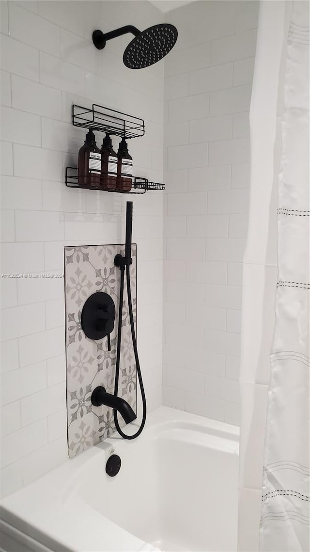 room details featuring shower / bath combination with curtain