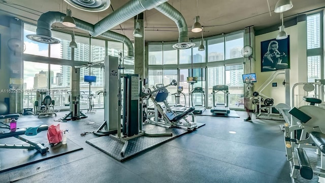 exercise room featuring a towering ceiling