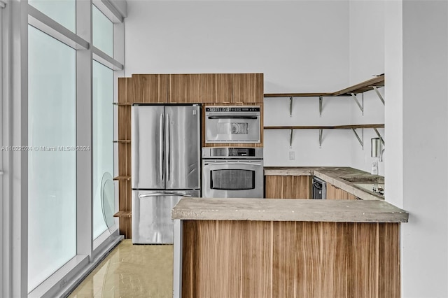 kitchen with white cabinetry and stainless steel refrigerator