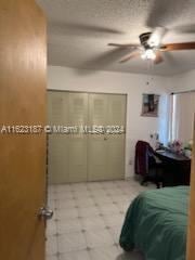 bedroom featuring ceiling fan and a closet