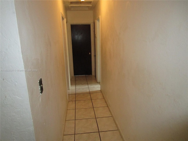 corridor with light tile patterned flooring