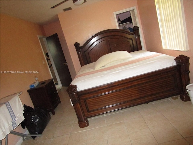 tiled bedroom with ceiling fan