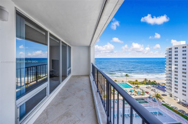 balcony with a beach view and a water view