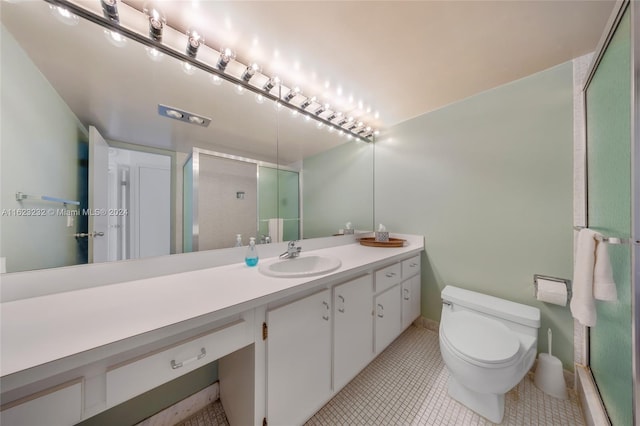 bathroom with vanity, an enclosed shower, tile patterned flooring, and toilet