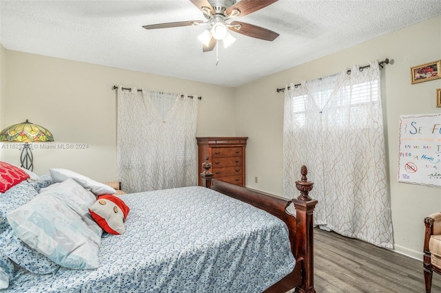 bedroom featuring a textured ceiling, hardwood / wood-style flooring, and ceiling fan