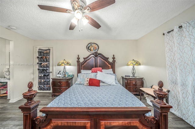 bedroom featuring a textured ceiling, dark hardwood / wood-style flooring, and ceiling fan