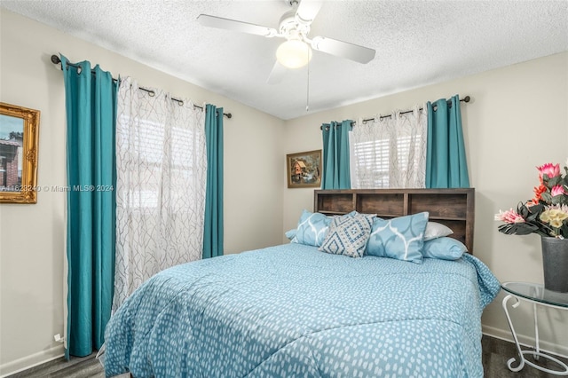 bedroom featuring a textured ceiling, ceiling fan, and hardwood / wood-style floors