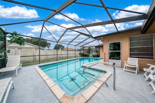 view of swimming pool with a patio and glass enclosure