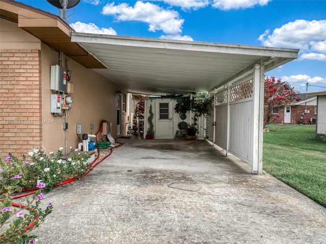 view of car parking with a yard and a carport