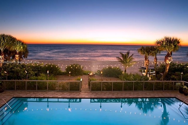 pool at dusk with a water view