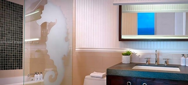 bathroom with tasteful backsplash, toilet, and vanity