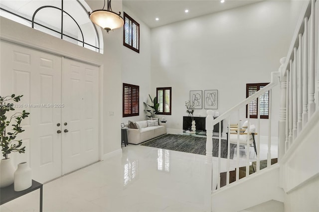 entryway with a towering ceiling and plenty of natural light