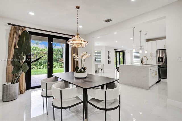 dining room featuring french doors and sink