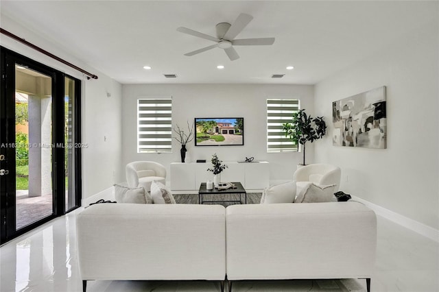 living room featuring french doors and ceiling fan