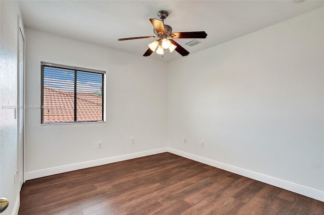 spare room with ceiling fan and dark hardwood / wood-style floors