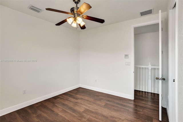 unfurnished room featuring dark wood-type flooring and ceiling fan