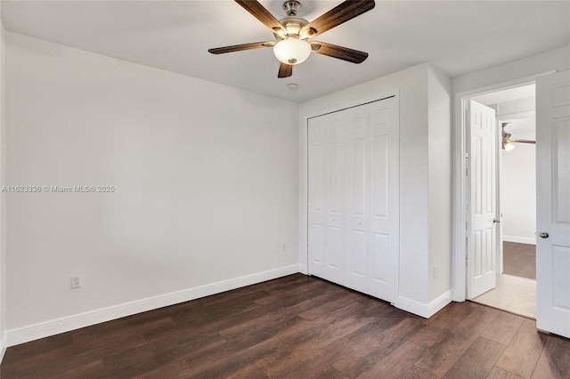 unfurnished bedroom with dark hardwood / wood-style floors, ceiling fan, and a closet