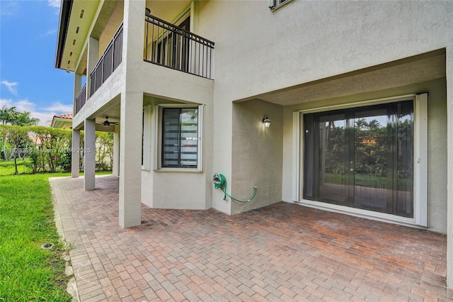 doorway to property featuring ceiling fan and a patio area