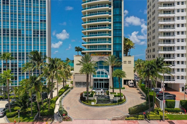 view of building exterior with uncovered parking