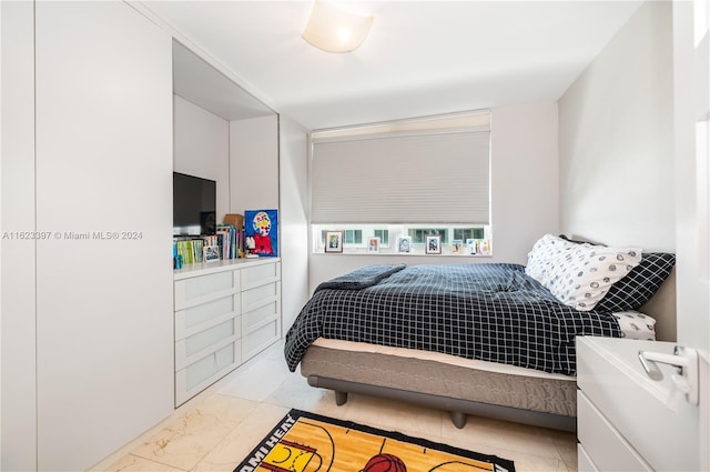 bedroom featuring marble finish floor