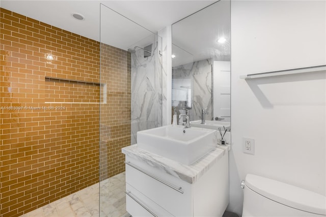 bathroom with a walk in shower, toilet, recessed lighting, vanity, and tile walls