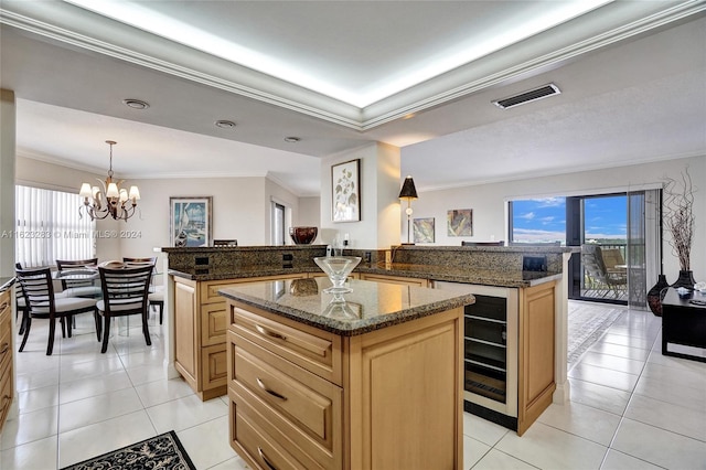 kitchen featuring a center island, dark stone countertops, and light tile patterned floors